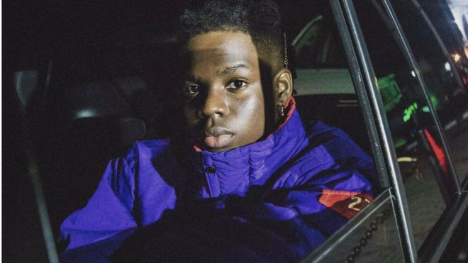 Fans Wear Face Masks To Welcome Rema To America (Video)
