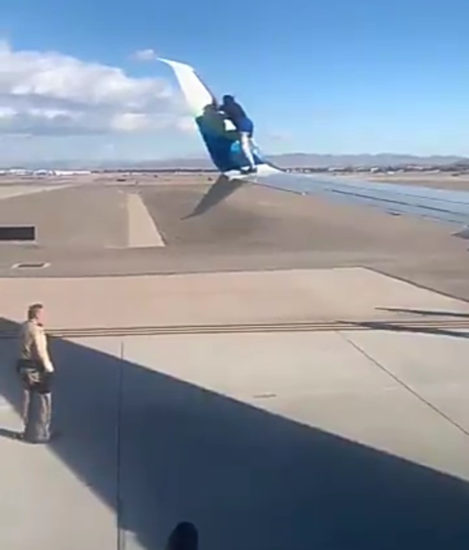 Man climbs wing of plane about to take off then falls off (video)