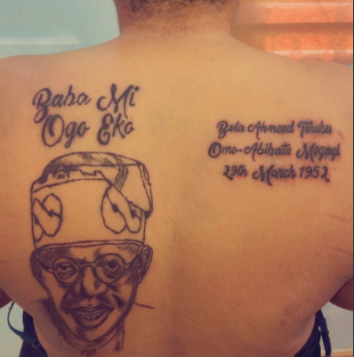 Lady tattoos Bola Tinubu’s face, name and date of birth on her back